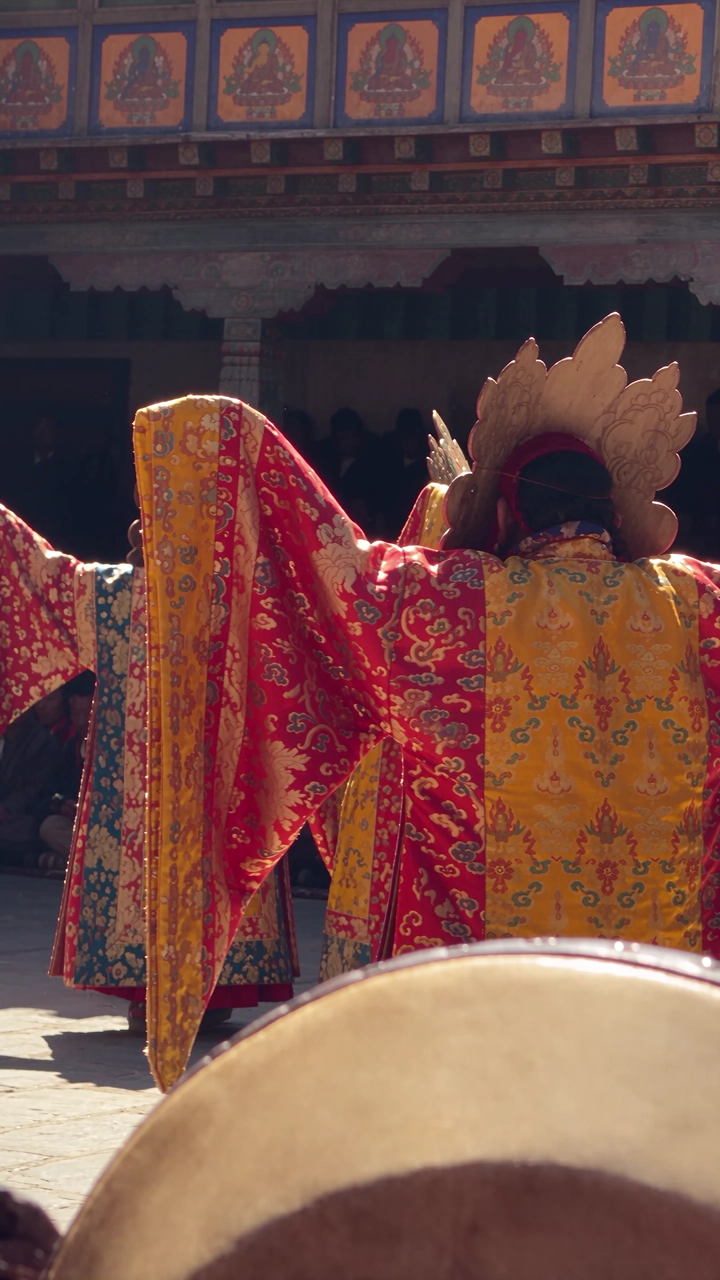 Masked dancers in a dzong courtyard during a tsechu