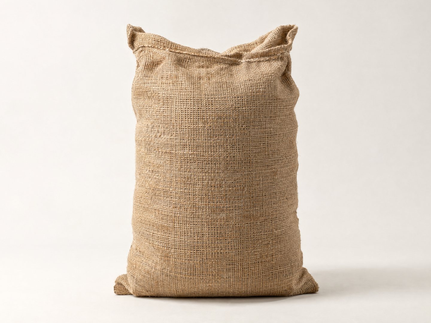 A standing woven sack of Bhutanese red rice photographed against a plain light ground
