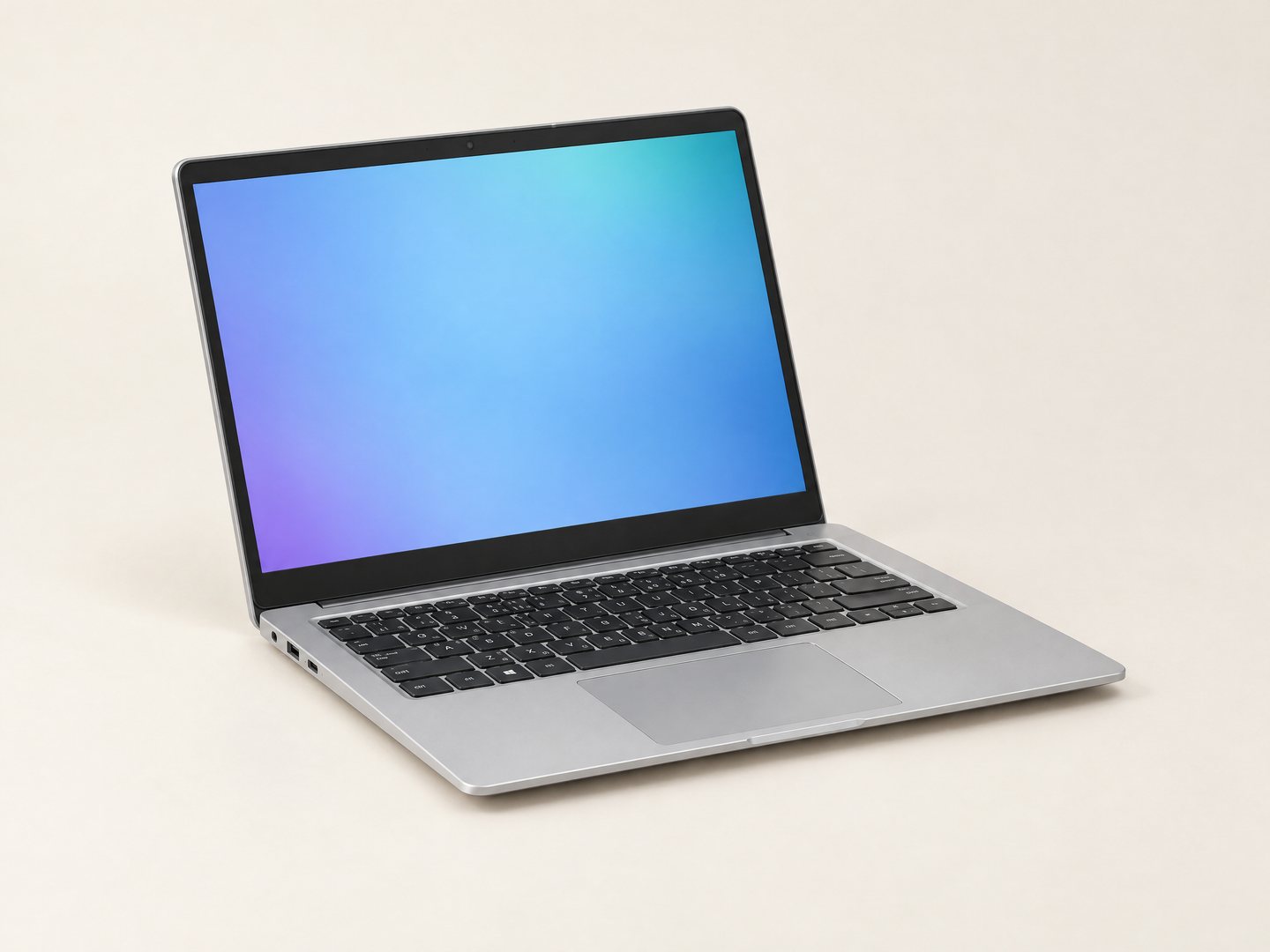 A refurbished silver laptop, open, photographed in a studio against a plain light ground