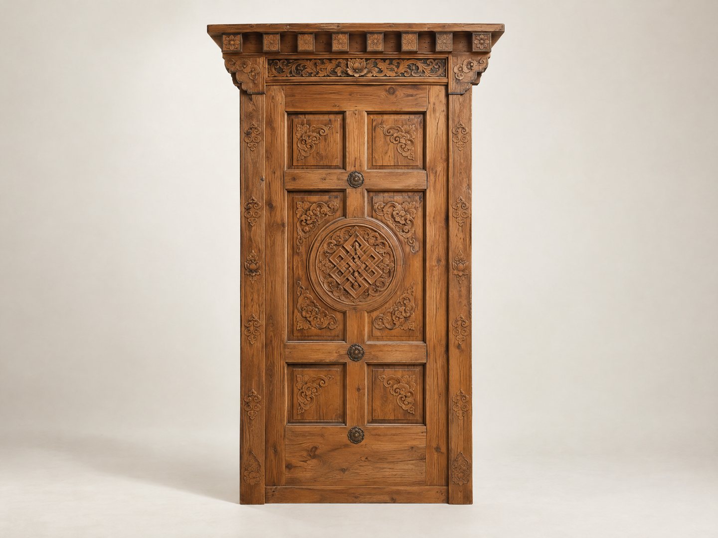 A solid carved hardwood door standing against a plain light ground